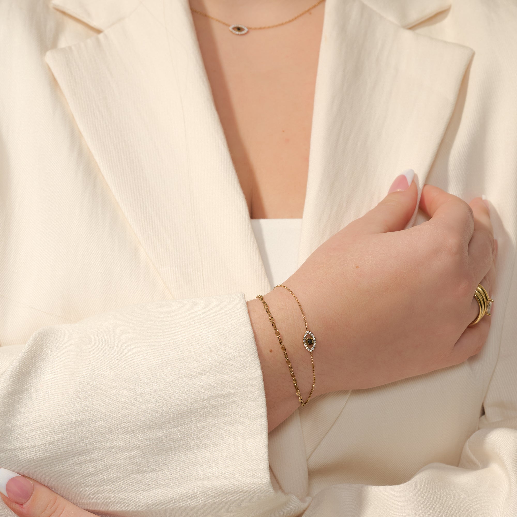 Dainty evil eye gold chain bracelet with black stone and cubic zirconia paired with matching evil eye pendant necklace – hypoallergenic, non-tarnish stainless steel jewelry by Mia Bijoux Canada