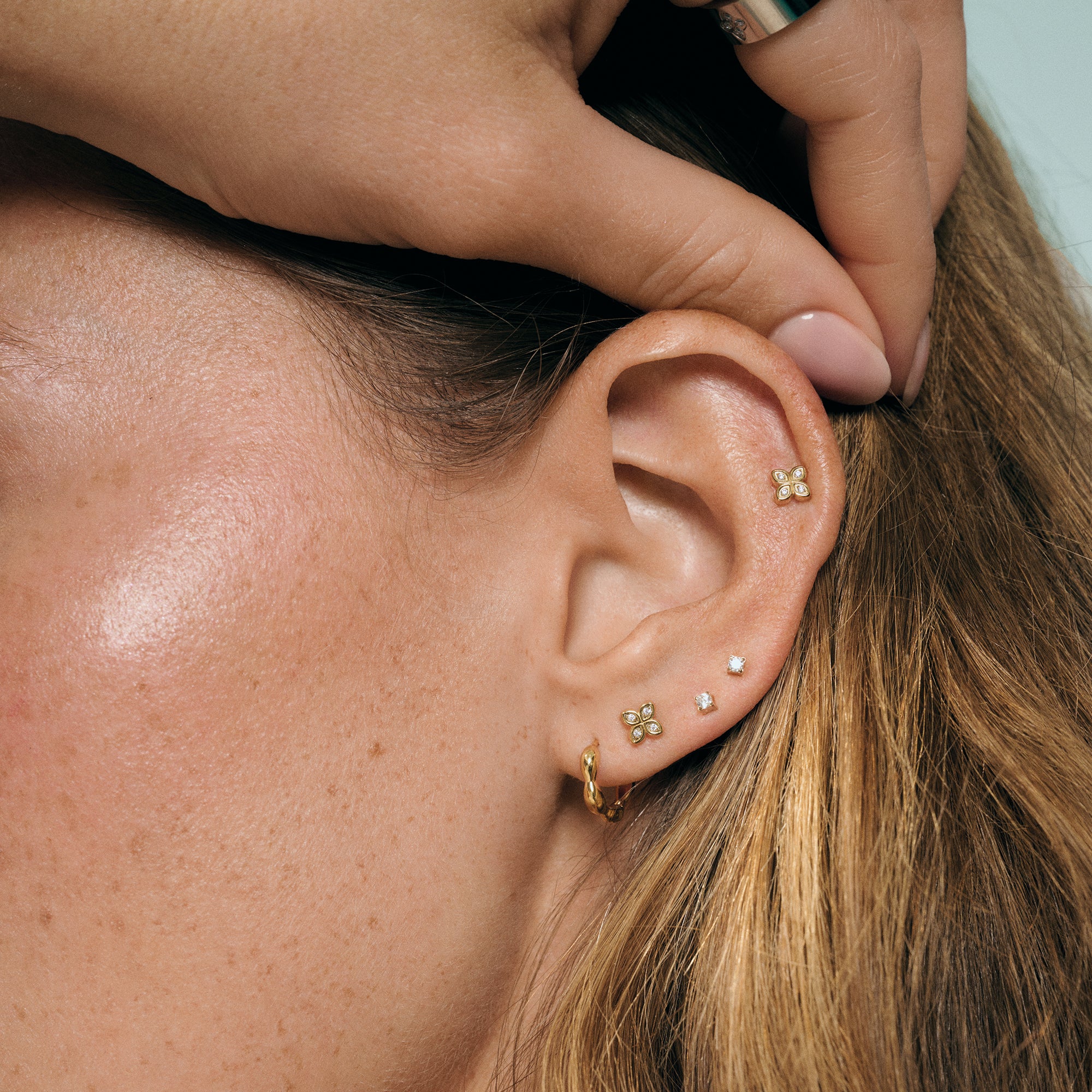 Gold stainless steel stud earrings and mini hoop stack, floral and cubic zirconia details, hypoallergenic earrings for sensitive ears, lightweight tarnish resistant jewelry in Canada.