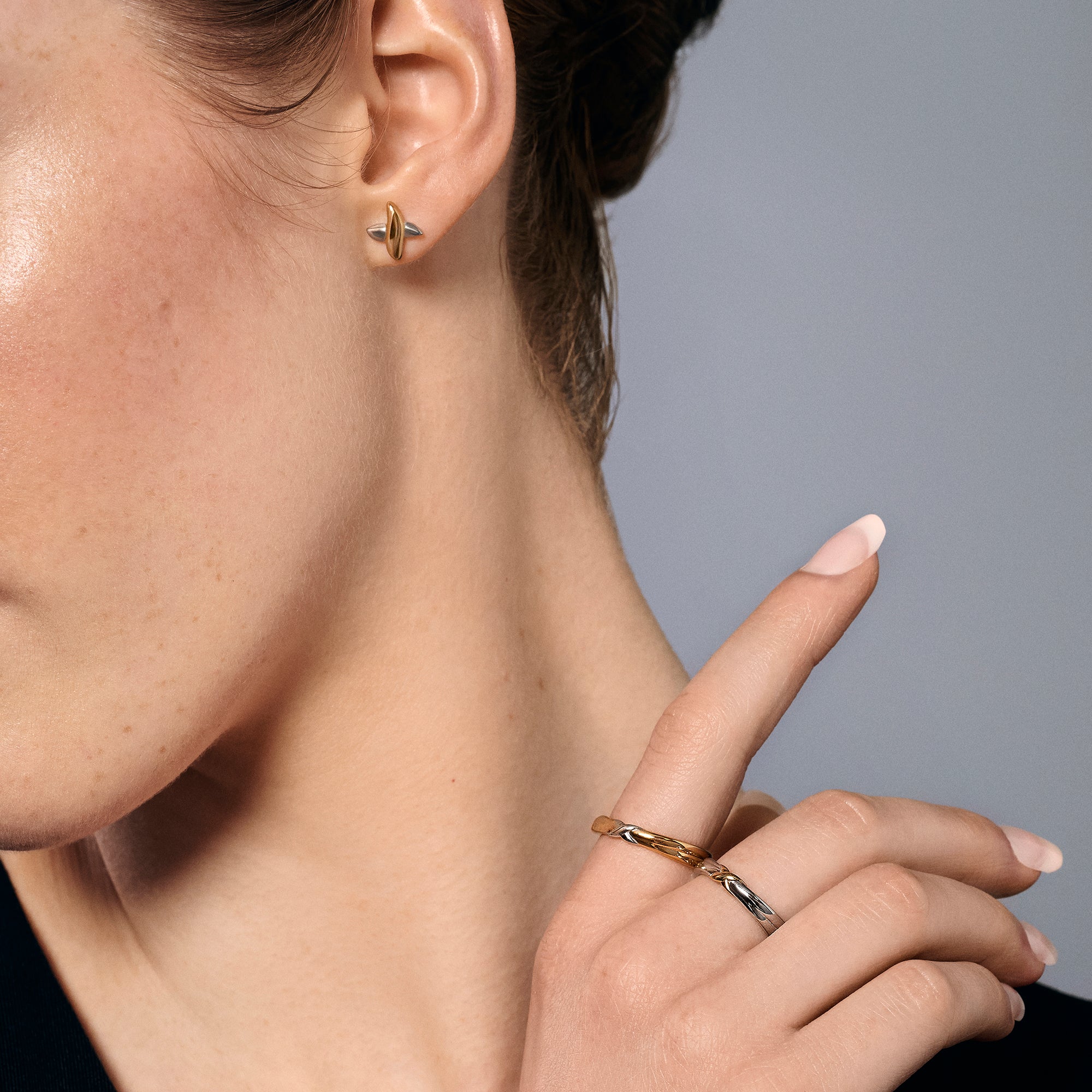 Two-tone stainless steel stud earrings and matching crossover rings in gold and silver, minimalist everyday jewelry, hypoallergenic non-tarnish durable jewelry Canada.
