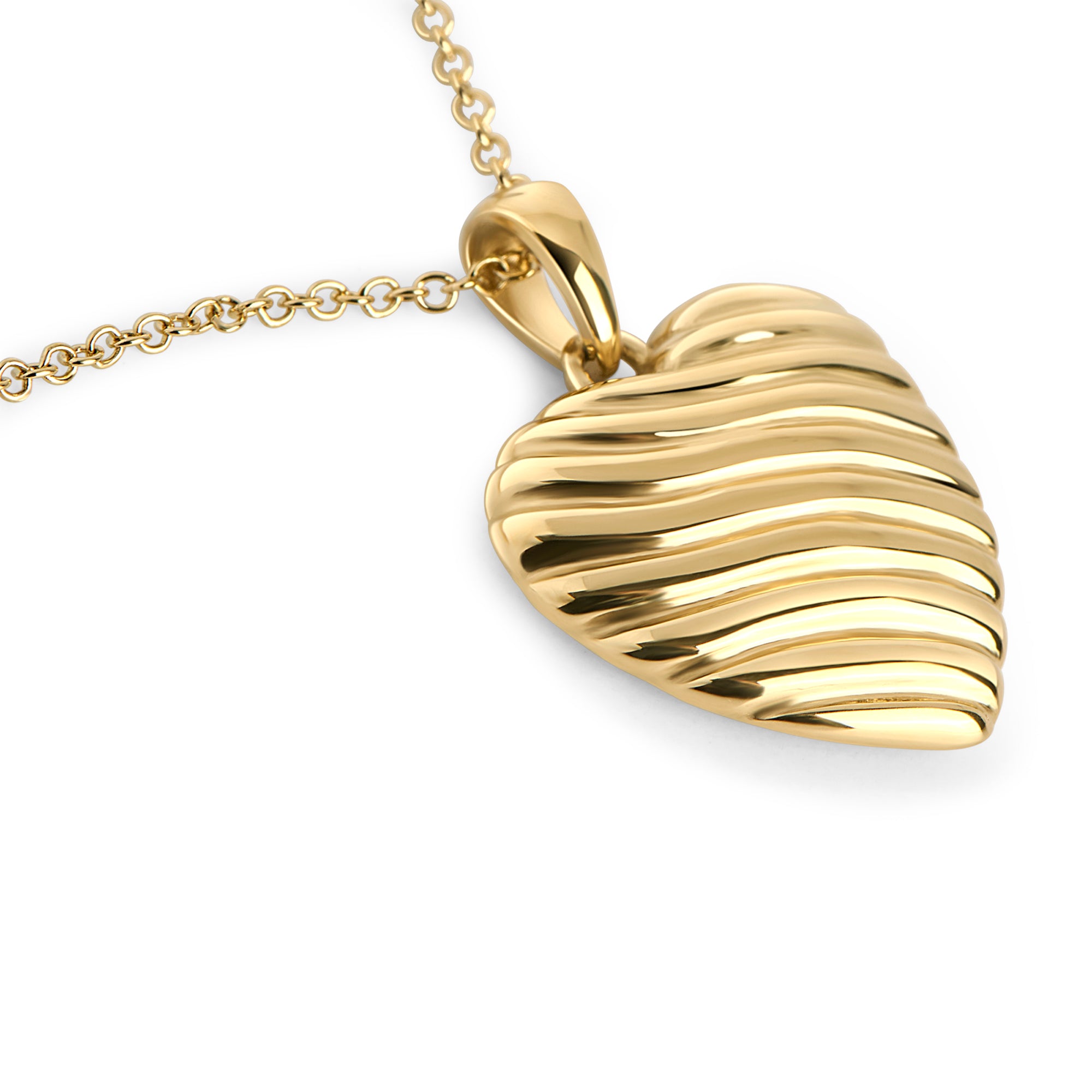 Gold stainless steel ribbed heart pendant necklace close-up, sculptural romantic jewelry design, hypoallergenic non-tarnish durable statement necklace, modern elegant heart jewelry.
